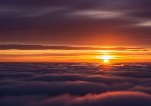 Aerial view of a sunset with orange sun above a sea of clouds and a dark purple sky above it
