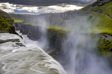 Fototapeta premium Gulfoss waterfall Water curtain cascading over green mossy cliff