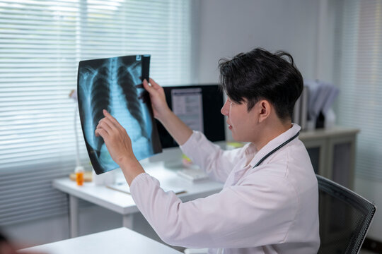Doctor examining chest x-ray for lung disease diagnosis in hospital office