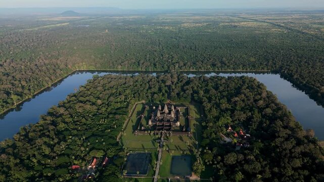 An aerial orbit right showcases Angkor Wat surrounded by forest and the moat, revealing the temple&rsquo;s layout and its landscape setting