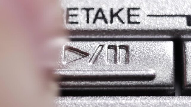 Finger pressing a silver retake button, symbolizing second chances and retrying