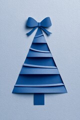 A vertical blue greeting card features a layered Christmas tree cutout with a small striped gift box tied by a blue ribbon, illustrating festive season, gift exchange, and holiday celebration