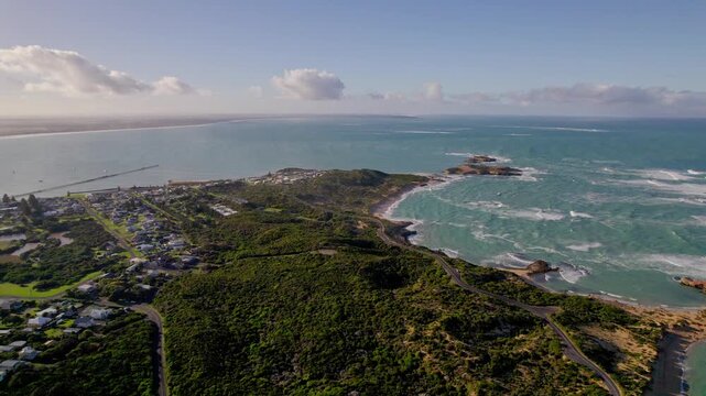 Aerial shot of Beachport with Penguin Island visible in the background out in the ocean. Clear water, rocky shoreline and the coastal township South Australian landscape.