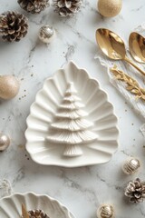 A vertical stylish holiday table featuring a leaf shaped ceramic plate, gold utensils, wrapped gift, ornaments, pine cones, and festive decor on a marble surface