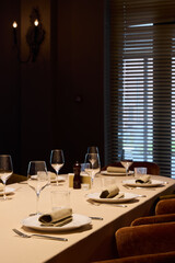 elegant table with dim lighting, cozy atmosphere with polished ware and gentle light filtering