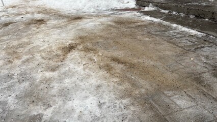 Technical salt on bare ice pavement at entrance in winter  