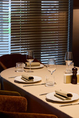 elegant midday dining arrangement, sophisticated lunch setting with beverages and proper lighting