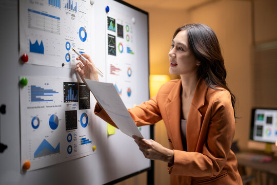 Businesswoman analyzing charts developing business strategy presentation