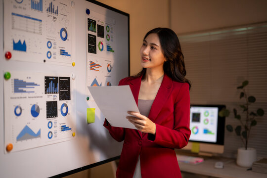 Businesswoman presenting data analysis charts in a board meeting - Powered by Adobe