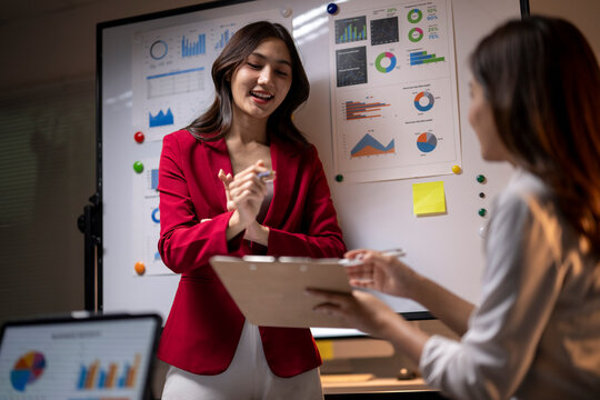 Businesswomen discussing financial data during office meeting