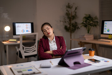 Businesswoman sleeping at desk after working late overtime