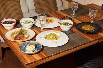 A Variety of Diverse Culinary Delights Arranged Elegantly on a Wooden Dining Table