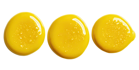 Three smooth, glossy yellow blobs of liquid on a black background