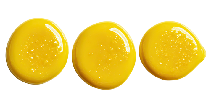 Three smooth, glossy yellow blobs of liquid on a black background