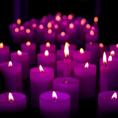 This image features a dramatic and intimate composition of numerous glowing purple candles, creating a warm, ethereal ambiance. The flames are bright, casting soft light and shadows across the many ca