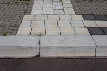 Textured pavement with contrasting tiles in various shades, showcasing a unique design and layout, blending functionality with aesthetic appeal in urban environments