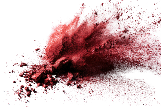Vibrant red powder explodes outwards against a dark background