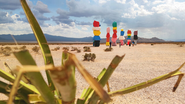 Las Vegas, Nevada, USA - 09.06.2025: Beautiful landscape view of the Seven Magic Mountains public art installation featuring colorful stacked boulders in the Ivanpah Valley desert with blurred green p