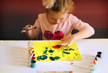 Ideas for drawing, cute girl painting greeting card. She is finger-paint during the art class to express her creativity. Painting is important to encourage child's imagination and creativity.