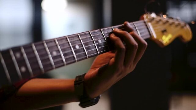 Close Up of Musician Playing Electric Guitar  in rehearsal studio  details on fingerboard