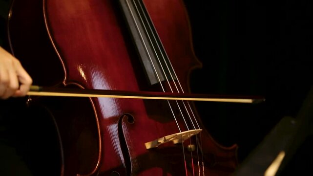closeup details of Musician Playing Cello with Bow in rehearsal studio