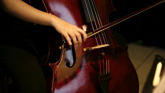 closeup details of Musician Playing Cello with Bow in rehearsal studio