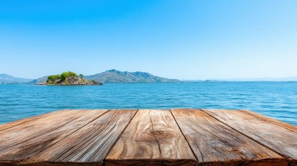 Fototapeta premium Calm waters stretch towards the horizon with a wooden dock in the foreground. A small island and distant mountains are visible under a clear blue sky creating a tranquil atmosphere.