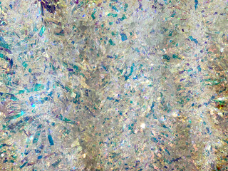 Obraz premium Close up background texture of christmas tinsels garland in silver and blue colors. Made of glossy materials, tinsels are used to decorate christmas tree or rooms in festivity. Merry Christmas