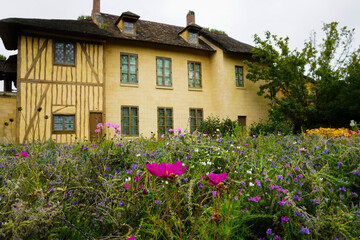 The Hameau de la Reine at Trianon, Marie Antoinette’s pastoral estate with charming rustic cottage buildings, landscaped flower gardens, showcasing  historic elegance and beauty of French countryside © faestock