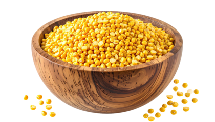 Wooden bowl filled with small yellow lentils
