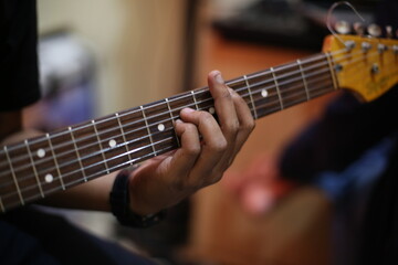 Obraz premium Close-Up of hand Musician Playing Electric Guitar in rehearsal studio