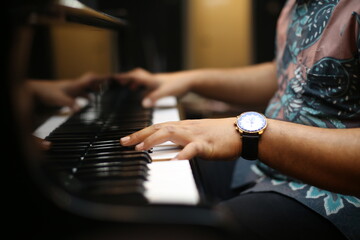 Hands Playing Piano Keys Close Up