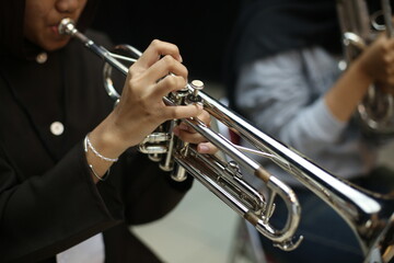 Obraz premium Closeup of Trumpet Player Practicing in a Music Rehearsal Room