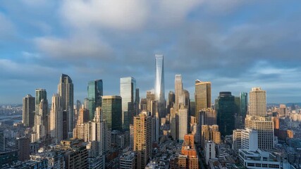 Aerial city view of a bustling metropolis with a theme of modern architecture during daytime, showcasing a time lapse of clouds moving across the sky.