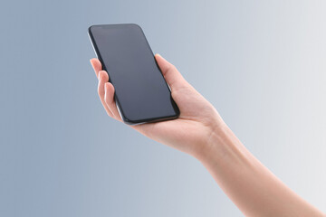 Hand Holding Smartphone with Blank Screen on Blue Background