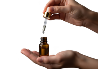 Hands dispensing essential oil drop into amber bottle, skincare serum concept isolated on transparent background