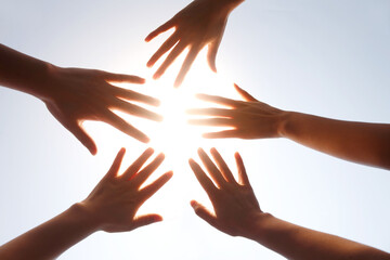 Hands Together in Circle Against Light - Unity and Teamwork
