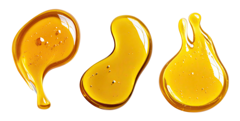Golden viscous liquid drips and blobs on a black background