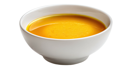 A bowl of vibrant, smooth, golden soup with a glossy finish