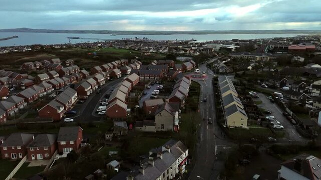 Rainy Holyhead homes aerial view rising above overcast small island town neighbourhood real estate