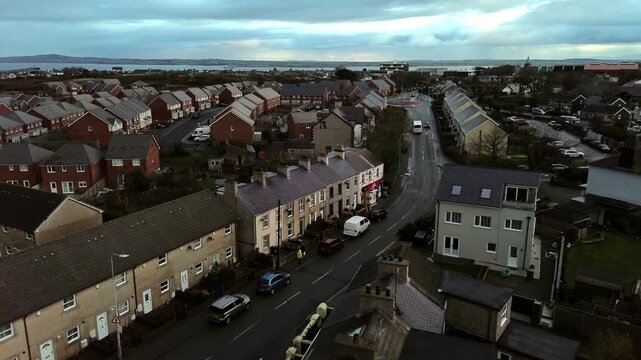 Rainy Holyhead homes aerial rising view over the small Welsh island town neighbourhood real estate