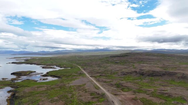 Aerial view of Hvammsfj&ouml;r&eth;ur archipelago along Road 54 in Vesturland Iceland, showing scattered islands, winding coastline, and open water under natural light.