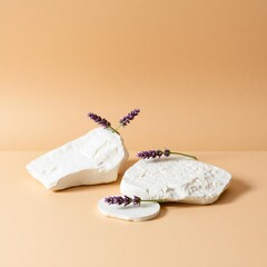 Minimalist arrangement of natural stones with lavender sprigs on a warm beige background