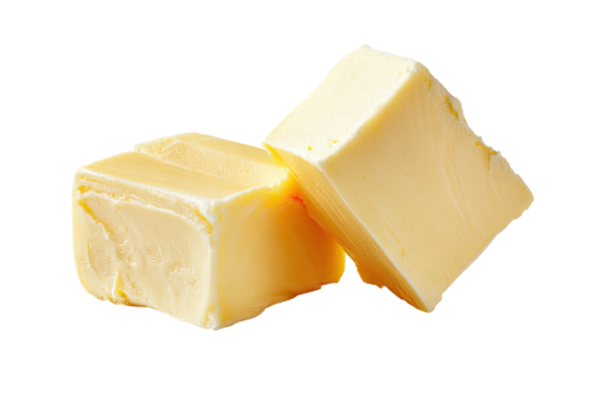 Two blocks of rich, golden butter on a black background