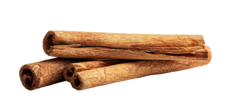 Several cinnamon sticks are piled on a black background