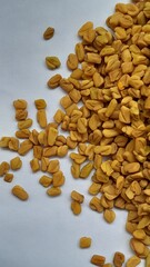fenugreek seeds on a white background