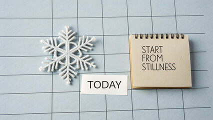 A snowflake and a calendar with motivational text on grid background