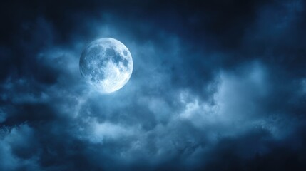 Fototapeta premium A luminous full moon glows in the night sky surrounded by wispy clouds. The scene captures the beauty of the moonlight against a backdrop of dark stormy weather creating a serene atmosphere.