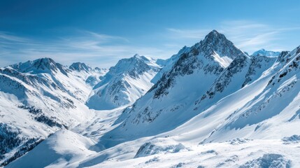 Fototapeta premium Snow covered mountains stand tall against a bright blue sky. The landscape features sharp peaks and gentle slopes showcasing the beauty of winter in a serene setting.