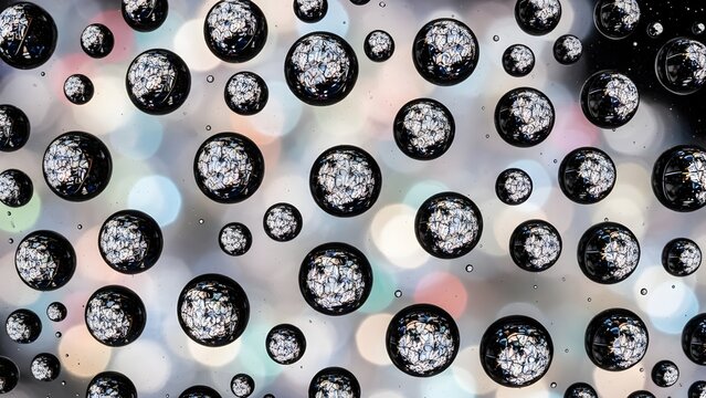 Macro of droplets reflecting christmas light bokeh pattern abstract art